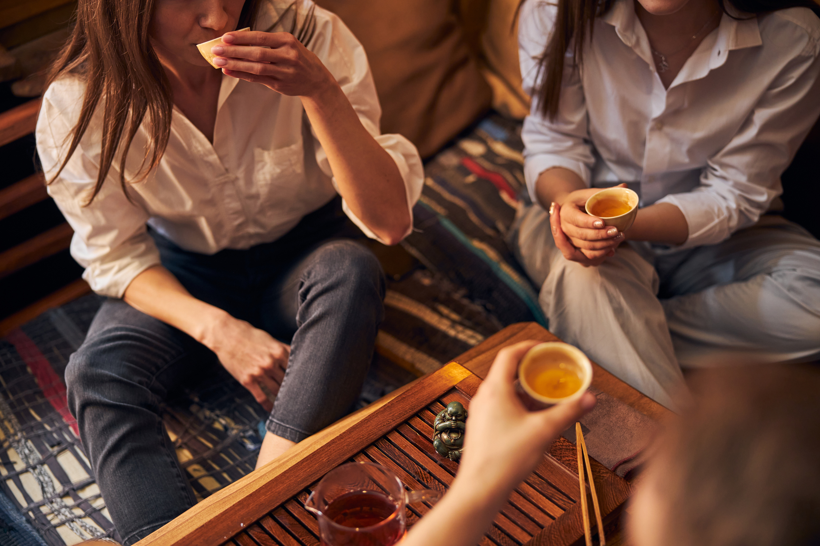 Young people drinking tea in cozy cafe